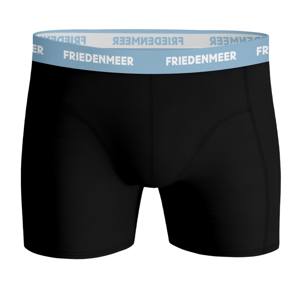 The image displays the upper body of an athletic man wearing the black boxer shorts by FRIEDENMEER, featuring a white 'FRIEDENMEER' text design on a light blue waistband, showcased and presented.
