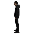 A sideview of an elegant person wearing a luxurious black FRIEDENMEER zip up hoodie with a unique logo design on the back, paired with stylish black trousers and modern shoes, showcasing high-end fashion.