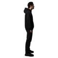 An elegant sideview of a model in a stylish, black FRIEDENMEER zip up hoodie and matching trousers, perfected with modern design, embodies the brand's timeless luxury and comfort.